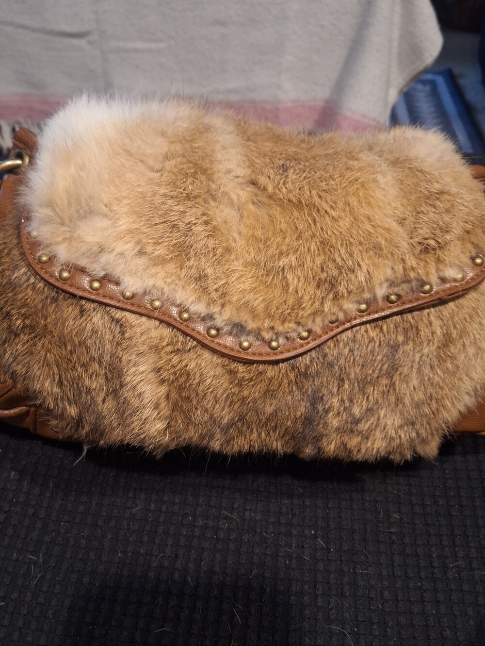 The Gianni Bini Women's Rabbit Fur Leather Purse is a stylish and unique